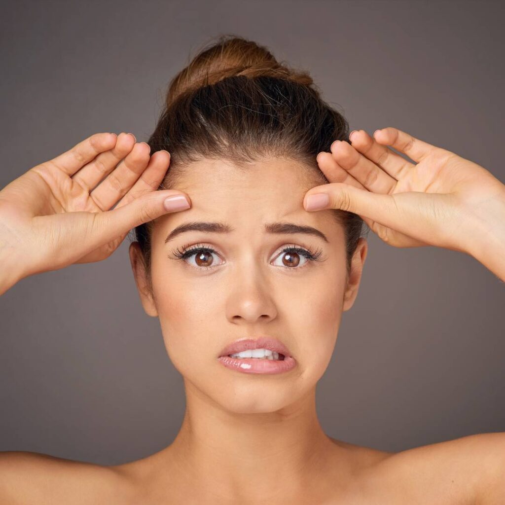 Girl making wrinkles on her forehead with worried look